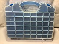 Front side of the plastic storage box showing 41 transparent compartments and handle.