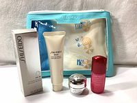 Photo of the full set including three Shiseido skincare items and a mint blue pouch.