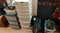 Photo showing two plastic storage drawer units stacked side by side with various smaller box organizers and items around them