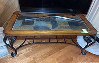 Front and top view of rectangular coffee table with slate tile inlay top and metal scroll legs