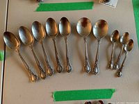 All ten spoons laid out by size on tabletop