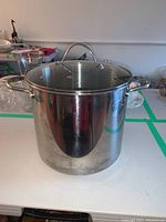 Full view of the stainless steel stock pot showing polished exterior and two side handles.