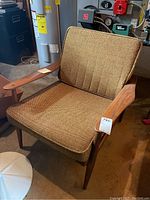 Front right three-quarter view showing wood frame and upholstered cushions