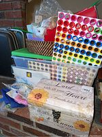 Comprehensive overview showing multiple storage containers including wicker basket, plastic bins, circular stamps, and decorative wooden chest with floral and inspirational lettering.