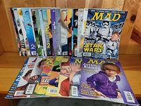 Front view of MAD magazines with covers showing popular culture subjects like Star Wars, Justin Bieber, Lego, and Donald Trump.