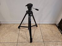Full view of the Hakuba HD-431V black camera tripod with three extendable legs and head with handle.