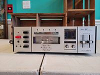 Front view of Sears Model 28607 solid state 8-track stereo tape deck showing power button, control buttons, headphone jacks, channel selector, tape slot, level meters, record and autorepeat knobs, volume sliders, model number and brand label.