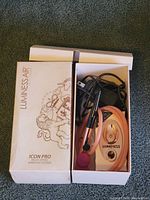 Luminess Air Icon Pro multi-speed airbrush system with power adapter and pink airbrush gun in original box with unicorn and star graphics.