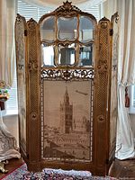 Full front view of the six-panel screen showing carved frame, mirrors and tapestry panels