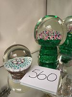 Overview of both paperweights on mirrored surface