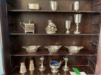 Overview of all miniature sterling pieces arranged on shelves