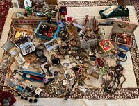 Overview of boxes and loose costume jewelry on table