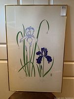 Full view of framed print showing iris flowers in metal frame and glass