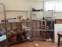 Two Metro chrome wire shelving units assembled side by side with assorted decorative items
