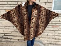 Full-view of cape worn, showing open front and wide drape