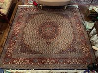 Full view of square carpet laid on wooden floor with sofa edge visible