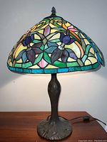 Full front view of lamp on table, lit