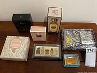 Overview of nine boxed and sample fragrance items arranged on table