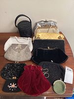 Overhead view of all 11 evening purses on wooden surface