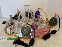 Full lot on mirrored tray showing all bottles and atomizers arranged in two rows