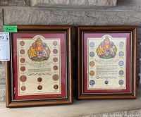 Two framed Canadian coin collections with coins arranged around a detailed coat of arms, both labeled respectively as penny and nickel collections.