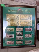 Framed art print titled 'End of an Era The Last One Dollar Bills of Canada' with images of Canadian one dollar bills from 1870-1975, showing multiple bills and description text.