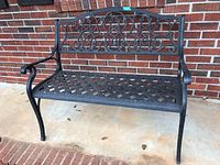 Front view showing intricate scrollwork on the backrest, lattice design on the seat, curved armrests, and overall structure of the bench.