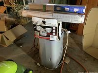 Hisense dehumidifier with LED security light box and fabric window shades on top in basement setting