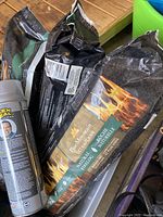 Photo showing three bags of Pine Mountain Ultra Flame natural fire logs with black packaging
