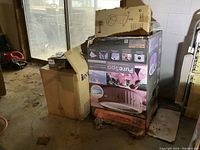 Stacked Intex PureSpa and related component shipping boxes on concrete floor