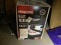 Box front showing Shop-Vac branding, 5 US gallons capacity, and 4.5 peak HP motor info.