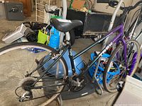Side view of Trek 720 women's bike in garage showing dual-tone frame and general setup.