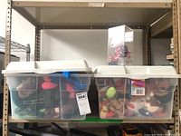 Two clear plastic storage bins filled with assorted Beanie Babies plush toys