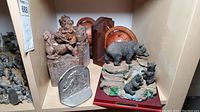 Overview photo showing all bookends including stone dragon dogs, bear figurine, lion plaque, and wooden globe bookends