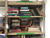 Shelf of assorted books with various subjects including baseball, culture, yoga, and historical books.