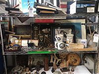 Shelf view with mugs, shadowboxes, brick, patches, photos, figurines and decals