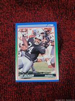 Front side of Bo Jackson football card featuring action image in Raiders uniform.