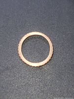 Top view of copper ring showing circular shape and ripple textured edge