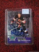 Front of the Daniel Alfredsson hockey card showing the player in Ottawa Senators uniform with a large blue autograph.
