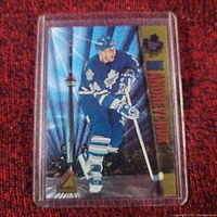 Front of the hockey card showing Dave Andreychuk in Toronto Maple Leafs uniform, holographic city background, Pinnacle logo, and player name in gold on right edge.