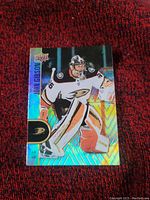 Front view of John Gibson Upper Deck hockey card displaying holographic design, Anaheim Ducks logo, and player image in goaltender stance.