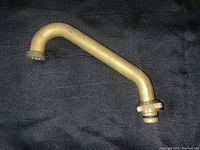 Solid brass curved sink tap with threading and fitting for garden hose connection, displayed on black background.