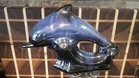 Side angled photo of the cobalt blue Blue Mountain Pottery dolphin figurine showing glossy glaze and color gradient.