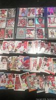 Photo of multiple Detroit Red Wings hockey cards spread out showing various players including Steve Yzerman, Nicklas Lidstrom, and others.