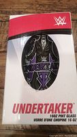 Front view of the original packaging showing the Undertaker illustration and product details.