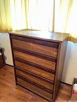 Front view of 5-drawer chest of drawers showing overall condition