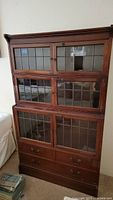 Full front view of three-stack barrister bookcase showing all glass-fronted sections and bottom drawers