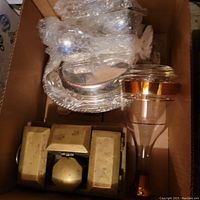 Top view of the lot showing obvious brass box at front, decanter and wrapped containers behind in box