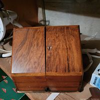 Closed wooden desk organizer showing smooth wood grain finish and latch on top