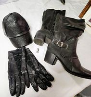 Photo showing black Barctraps wide calf boots with 2-inch heel, slouchy design, metal buckle strap, side zipper; black leather-like Disney baseball hat; black leather lambskin gloves with buttoned wrist closure and leather rose designs